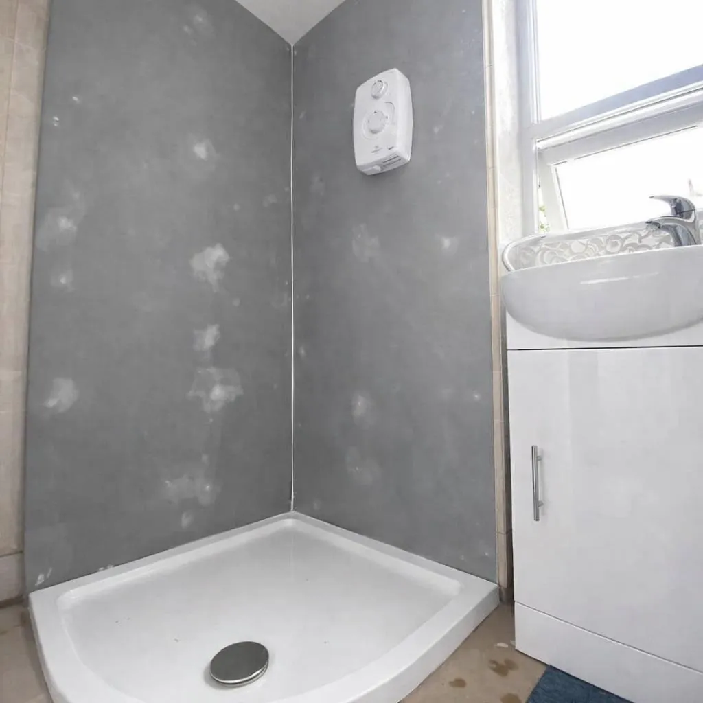 Spray granite shower being applied by Glasgow Microcement (photo 1)